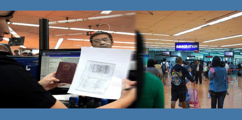 Immigration checks a passport Immigration checks a passport